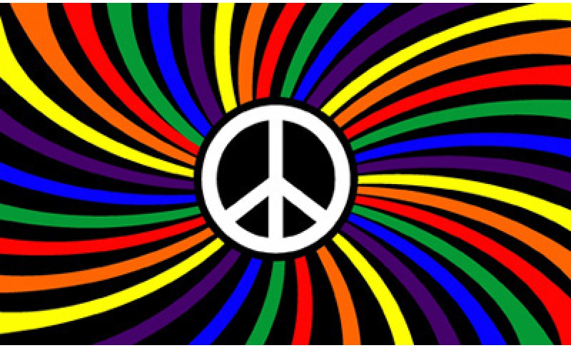 Rainbow peace flag: rainbow-coloured rays spiralling outward from the centre, separated by black, with a white circle at the centre containing the peace symbol.