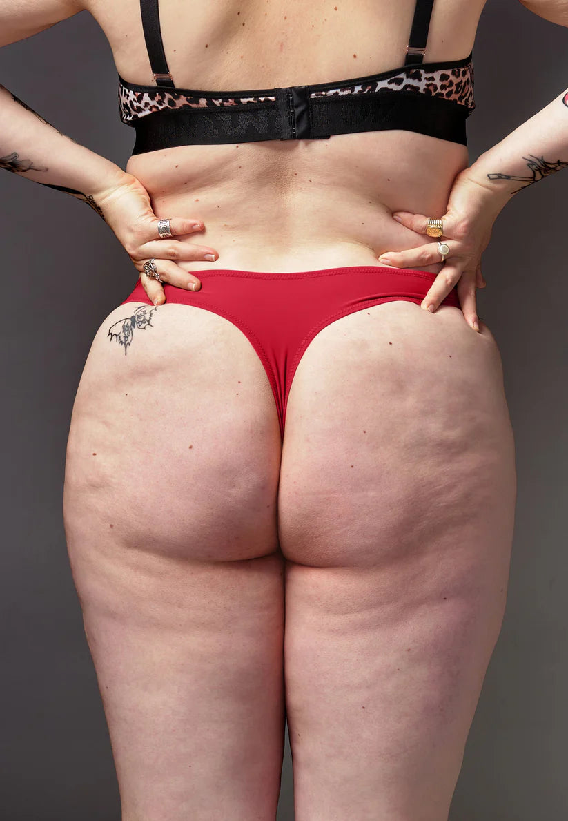 UNTAG corrective tucking thong back view in red